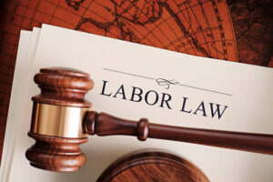 A gavel resting on a document titled "Labor Law."