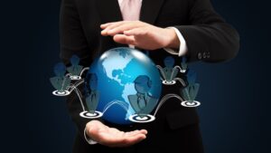 Businessman holding a globe with networking icons