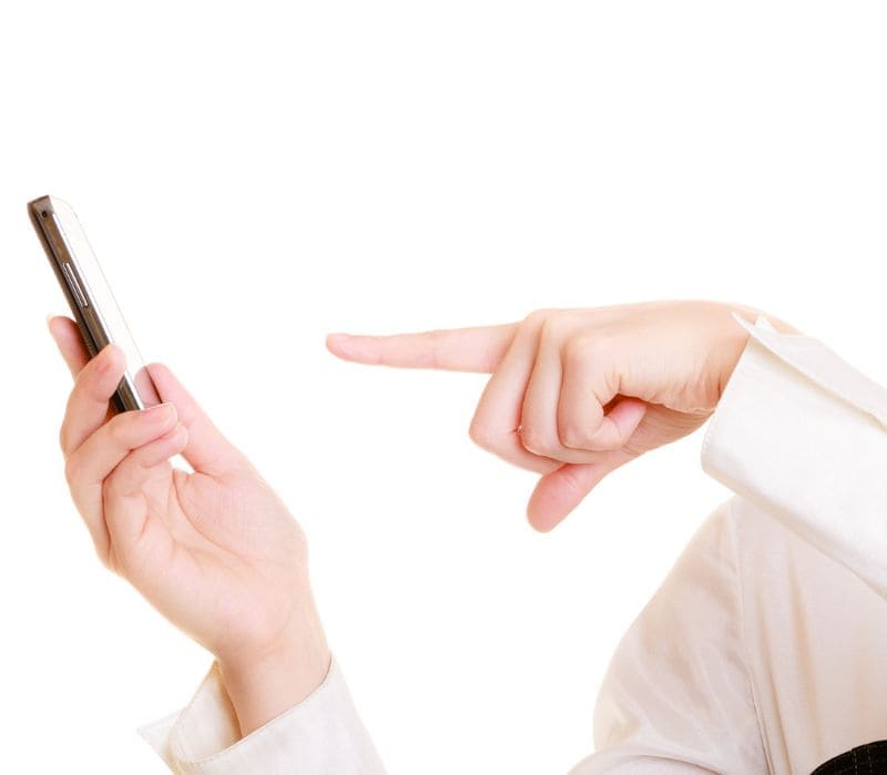 Person pointing at a smartphone screen