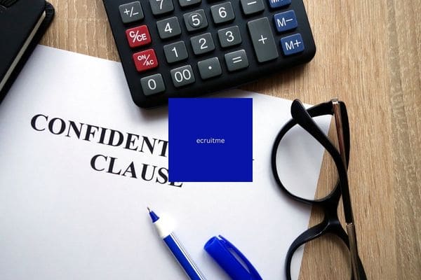 Confidential clause document with a calculator, pen, and eyeglasses on a desk.