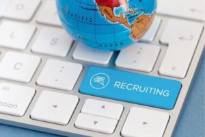 A globe on a keyboard with a blue recruiting key.