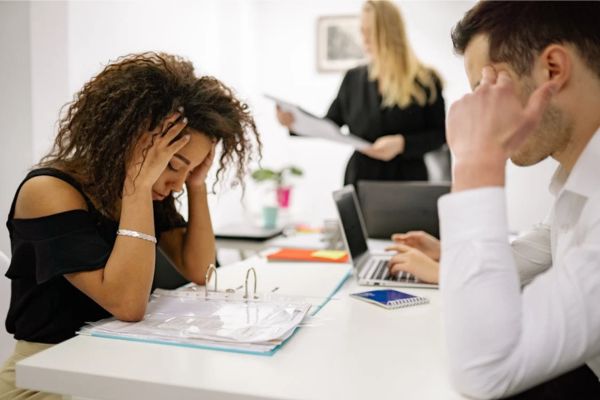 A stressed woman in an office.